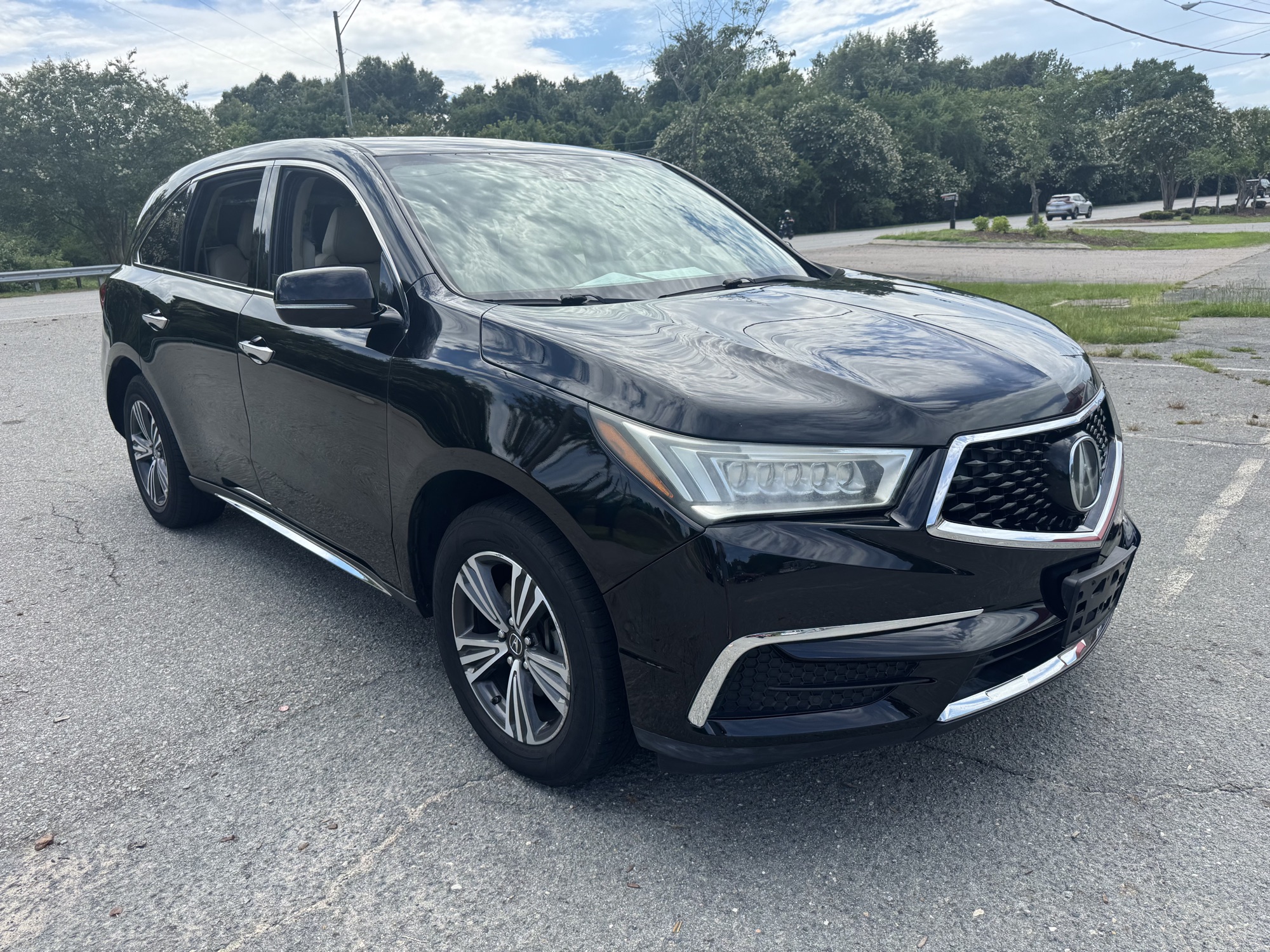 Front passenger side of the black Acura MDX
